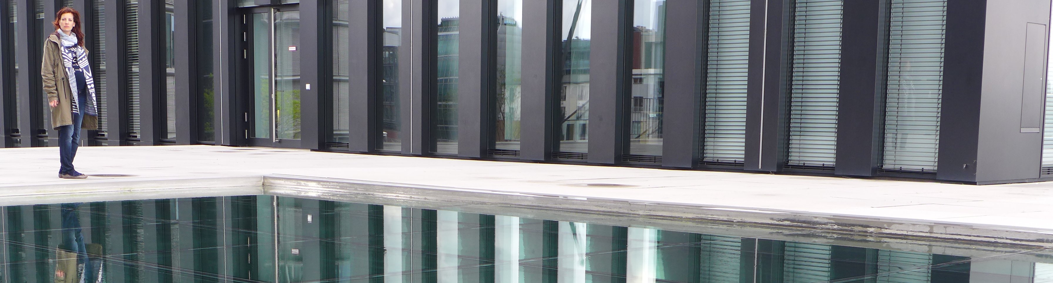 Häuserfront mit Frau im Fordergrund Überrascht.